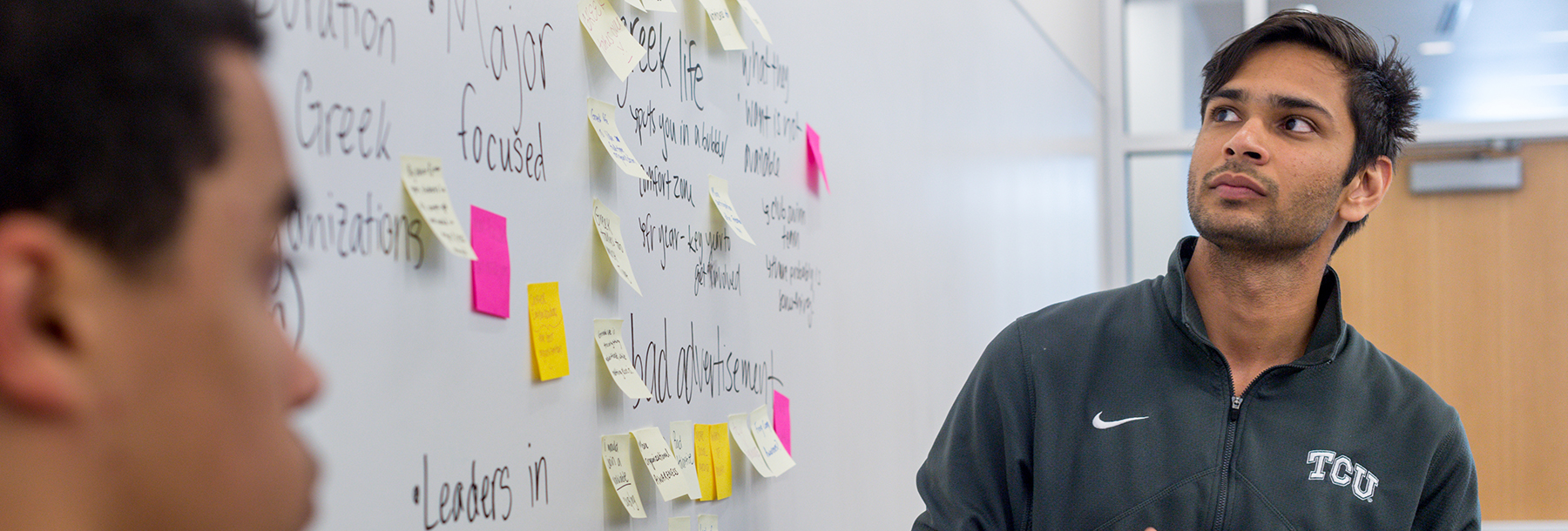 Section Image: Students at white board 