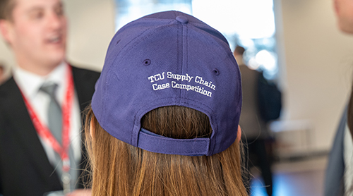 Section Image: University of Wisconsin team of Tobias Kern, Sajal Dixit, Saurabh Papppu and Juhi Goenka at the Neeley fountain wearing purple competition baseball hats 