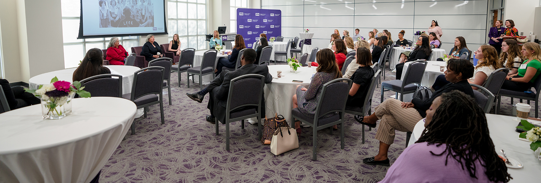 Section Image: Laura Miller, Rosa Navejar and Amy Phipps in the Hays Banquet Hall addressing the audience. 