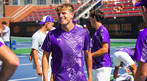 Section Image: Luke Swan serving during a tennis match 