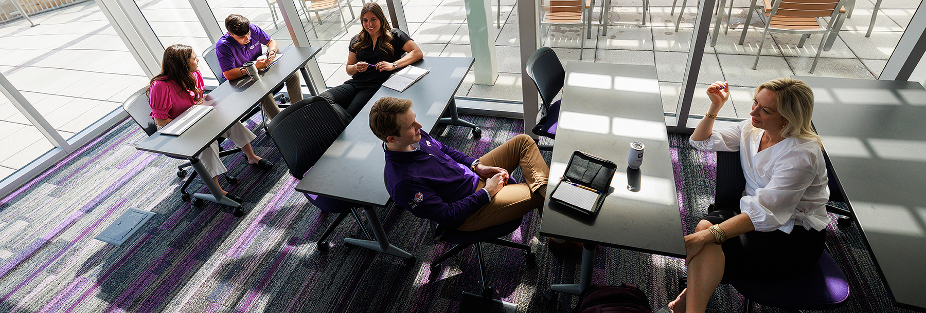 Section Image: Kelly Tragger in class with students taken from a high angle 